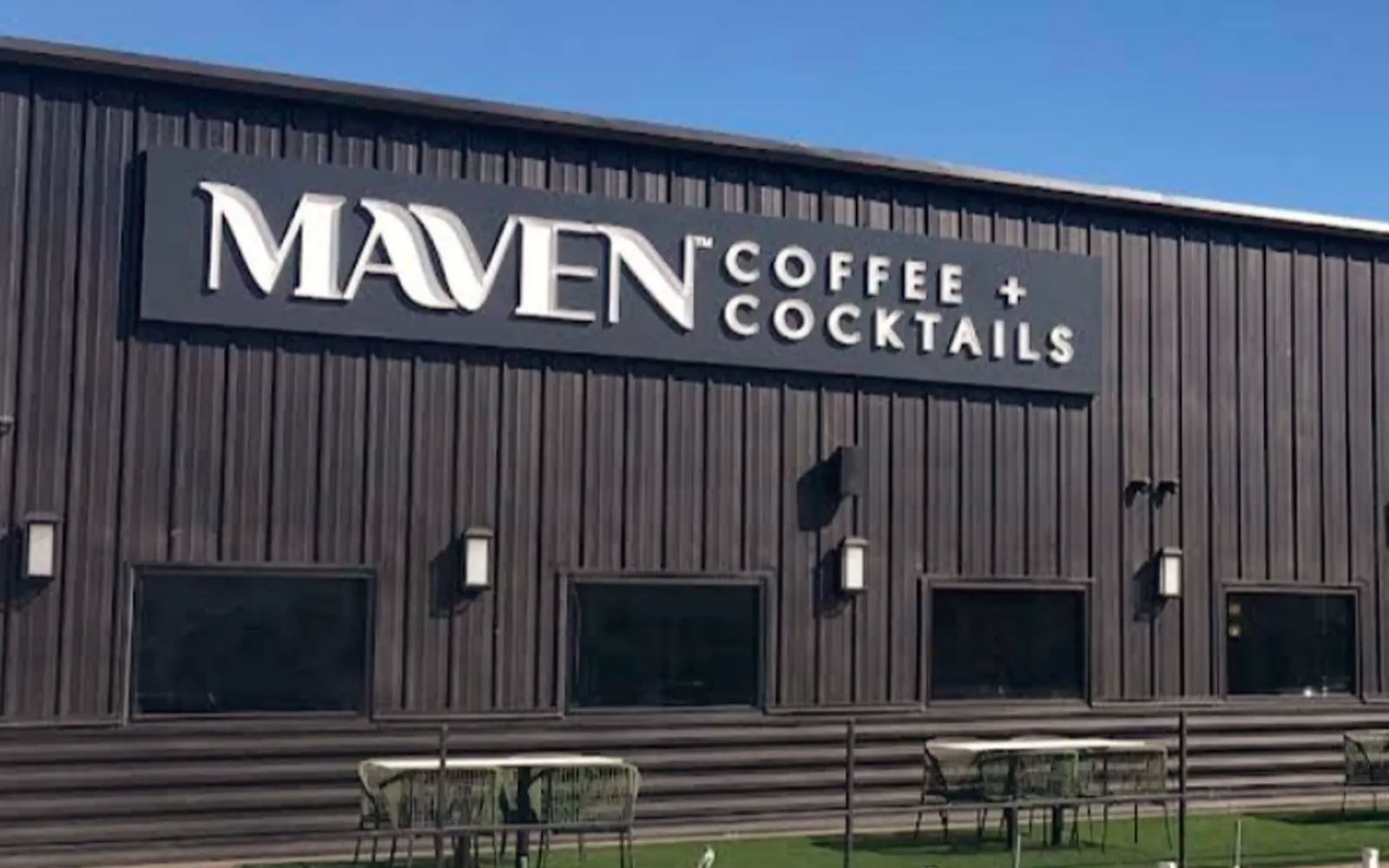 Maven Coffee and Cocktails: metal-clad building with steel entry canopies and perimeter fence